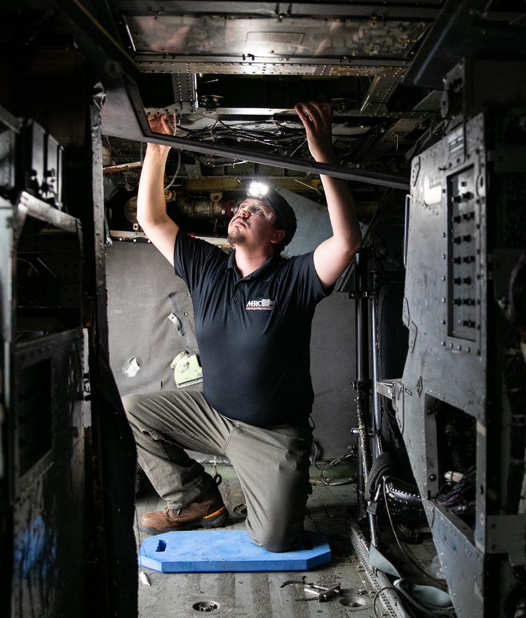 Man working inside of a airplane cockpit